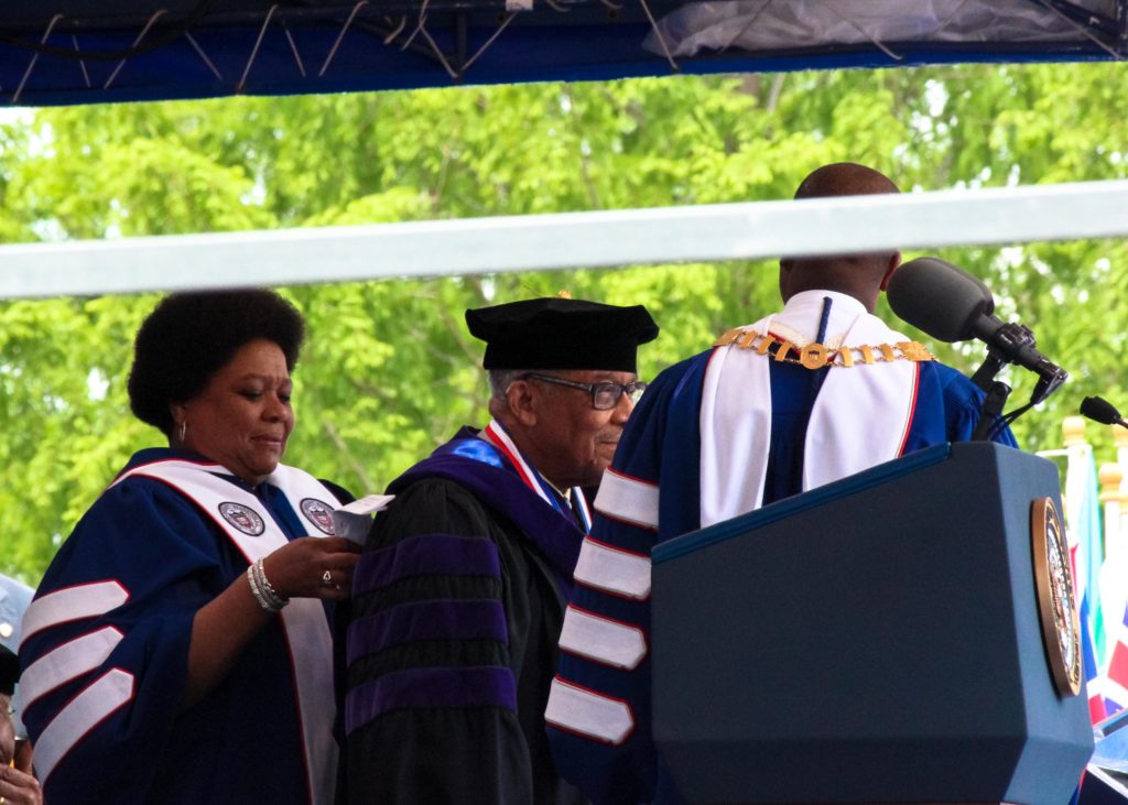 Ambassador Horace G. Dawson, Jr. (middle) receives his honorary degree in doctor of laws by Howard Board of Trustee member Charisse R. Lillie (left) and Howard President Wayne A.I. Frederick (right) May 7th during Howard University's 148th Commencement Convocation. (Photo Credit: Paul Holston/Editor-in-Chief/The Hilltop)