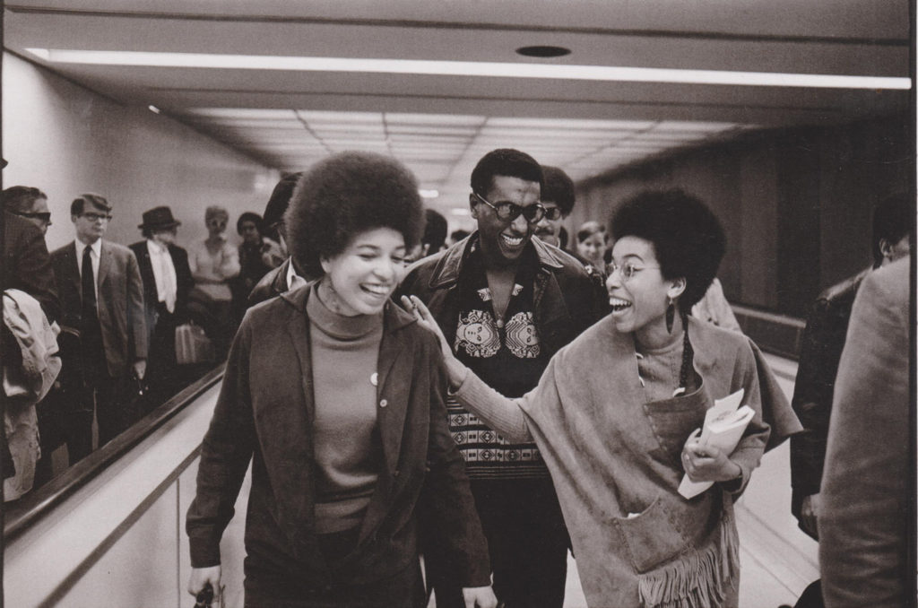 Activist Angela Davis (left), Black Panther Barbara Easley Cox, and Stokely Carmichael at the Los Angeles International Airport. (Photo Credit: Howard Bingham, 1968)